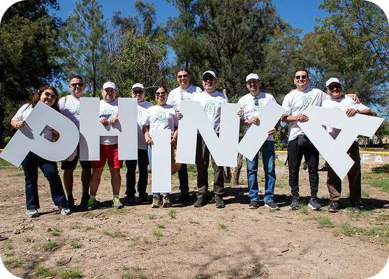 PHINIA employees posing together at a community volunteer event.